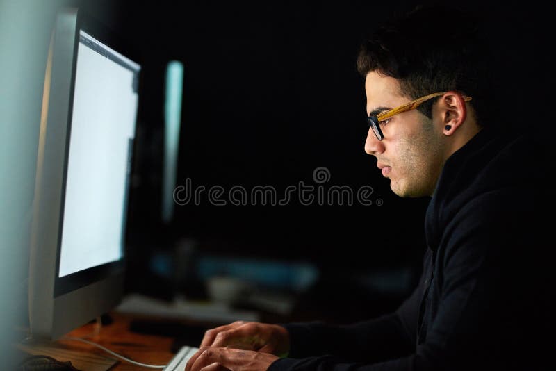 Computer, typing and man at night for software development, programming update and information technology. Focus royalty free stock image