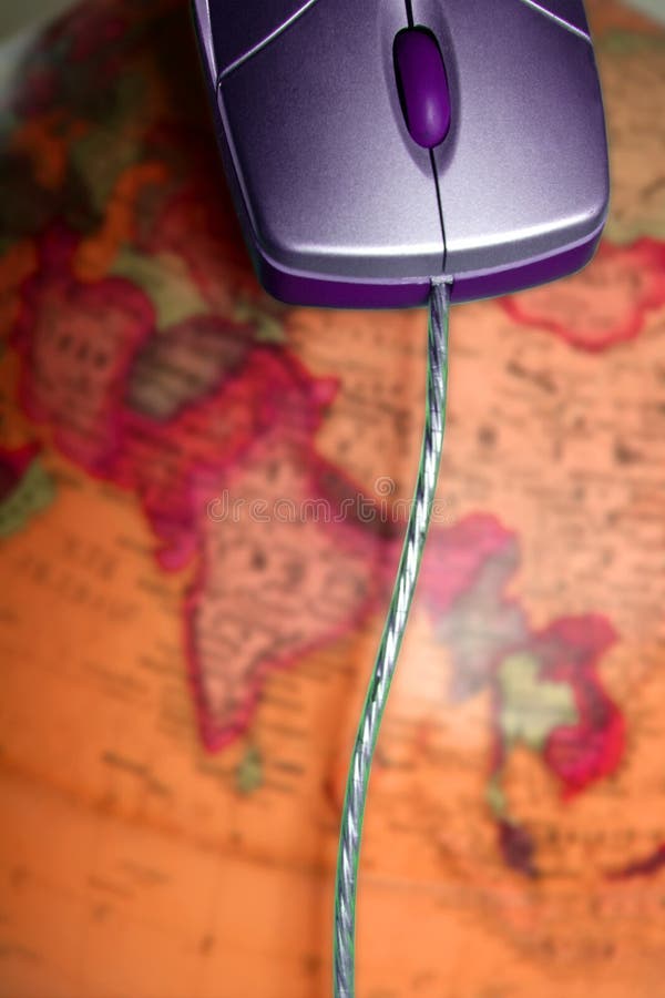 Computer wired mouse over the world colorful global earth map. Computer wired mouse over the world colorful global earth map