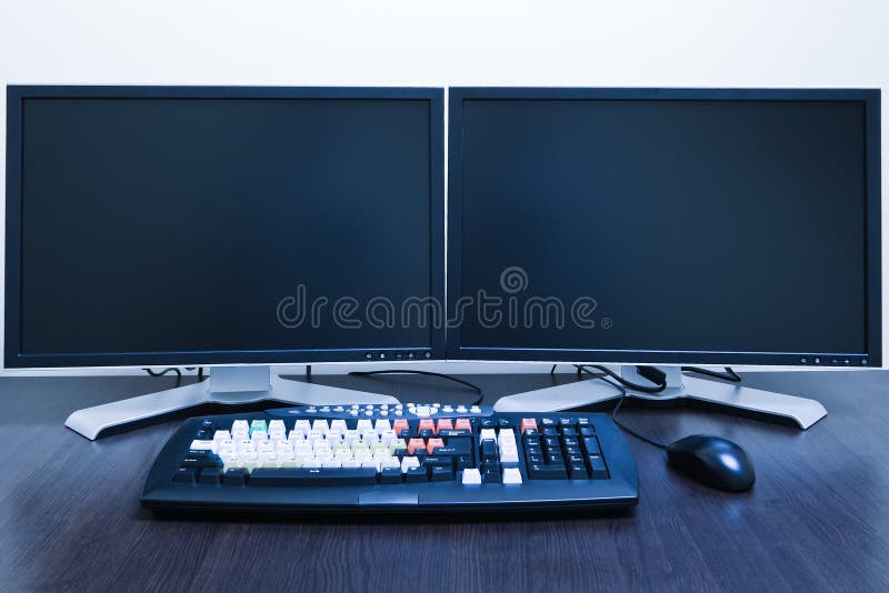 Computer workstation with two LCD screens blue toned. Computer editing stock images, royalty-free photos and pictures