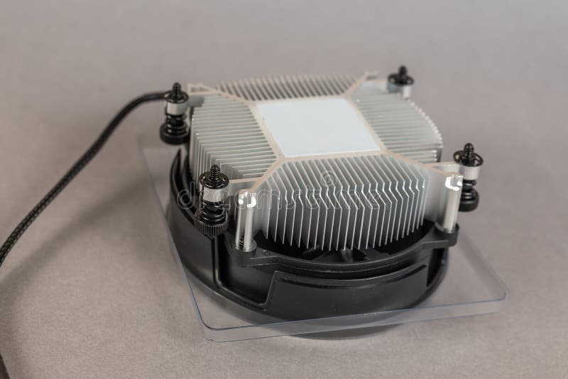 Computers and Components. New CPU fan against a gray background. Round aluminum device to cool the main CPU royalty free stock image