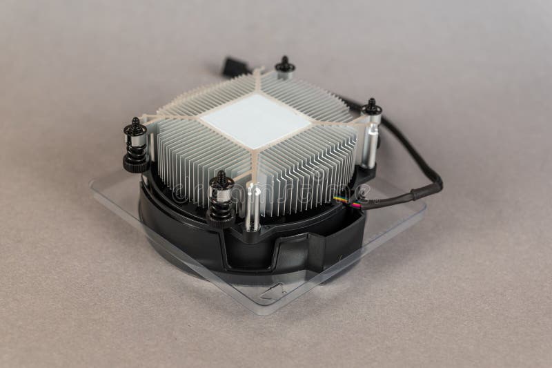 Computers and Components. New CPU fan against a gray background. Round aluminum device to cool the main CPU stock image