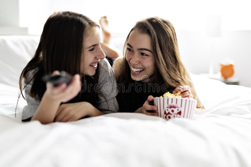 Conceito da amizade, dos povos, do partido de pijama, do entretenimento e da comida lixo imagem de stock Conceito da amizade, dos povos, do partido de pijama, do entretenimento e da comida lixo imagem de stock