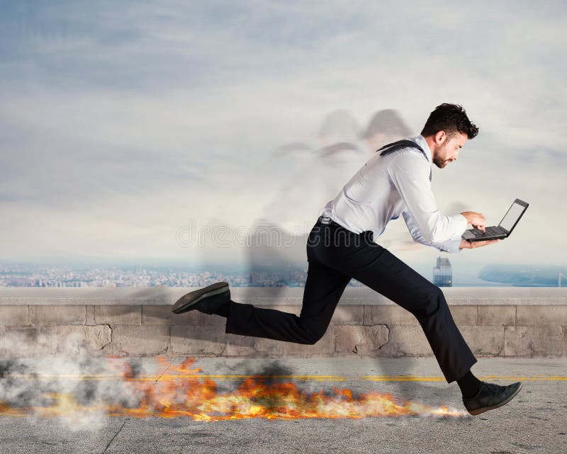 Businessman runs quickly with laptop leaving fire trails. Fast business concept. Businessman runs quickly with laptop leaving fire trails. Fast business concept