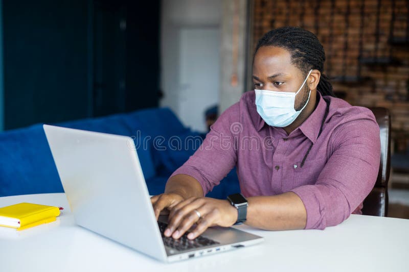Concentrated African American Male Employee Wearing Medical Mask