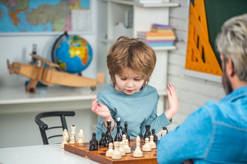 Concentrated boy developing chess strategy, playing board game. Thinking kid. Chess, success and winning. royalty free stock images Concentrated boy developing chess strategy, playing board game. Thinking kid. Chess, success and winning. royalty free stock images