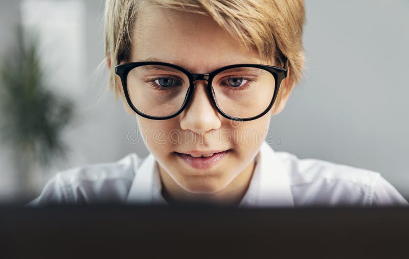 Concentrated Boy Gazing at the Screen royalty free stock image