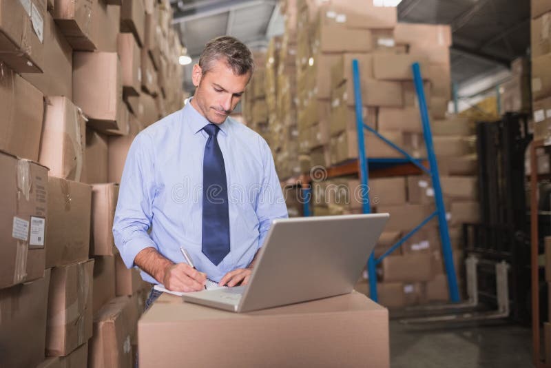 Workman Using Laptop at Warehouse Stock Photo Image of laptop