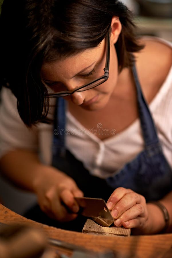 Concentration is key. An artist creating something out of wood. royalty free stock images