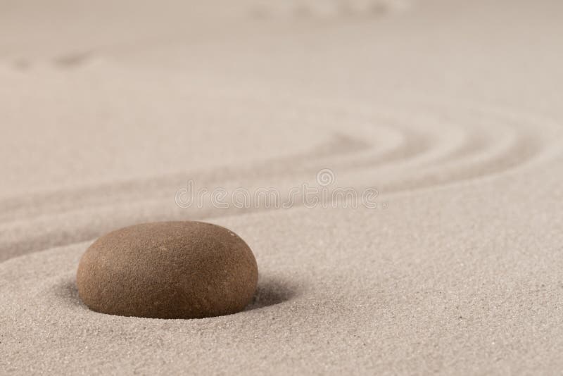 Concentration trough focus on a zen meditation stone. Round rock in sand texture background royalty free stock photos Concentration trough focus on a zen meditation stone. Round rock in sand texture background royalty free stock photos