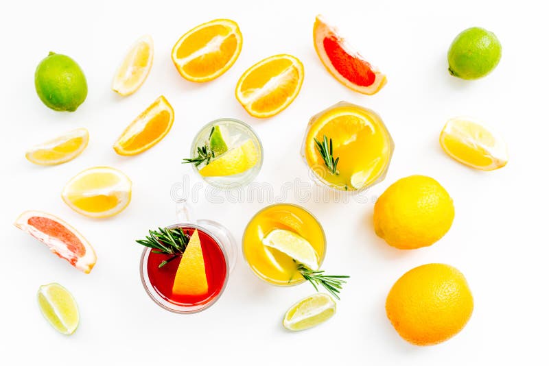 Concept of alcoholic cocktail with fruits. Glass with beverage near oranges, grapefruit, lime and rosemary on white. Background top view stock photos Concept of alcoholic cocktail with fruits. Glass with beverage near oranges, grapefruit, lime and rosemary on white. Background top view stock photos
