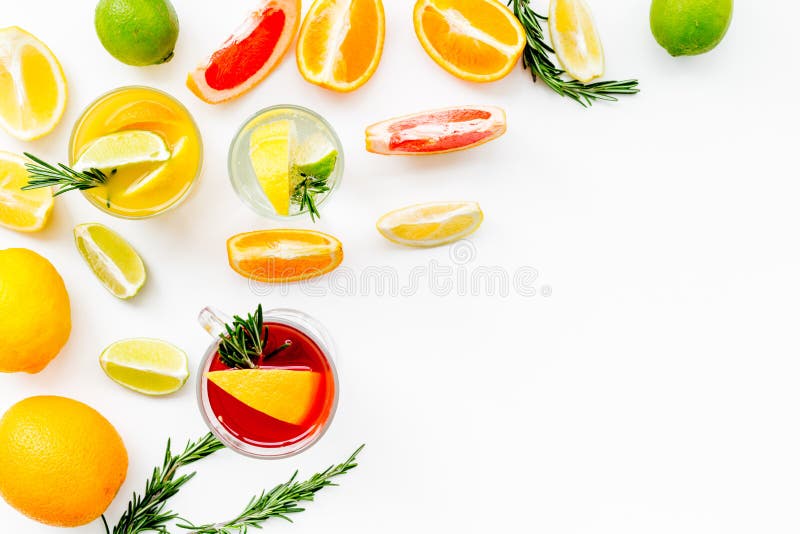Concept of alcoholic cocktail with fruits. Glass with beverage near oranges, grapefruit, lime and rosemary on white. Background top view royalty free stock photo Concept of alcoholic cocktail with fruits. Glass with beverage near oranges, grapefruit, lime and rosemary on white. Background top view royalty free stock photo