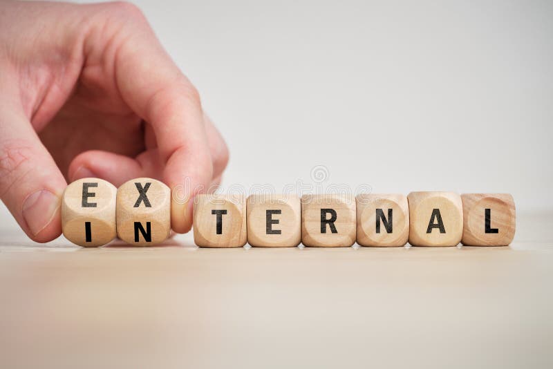 Concept of antonym external and internal on wooden blocks stock photography