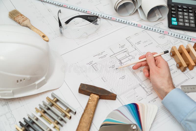 Concept architects or engineer holding pencil pointing equipment architects. On the desk with a blueprint in the office. stock photography Concept architects or engineer holding pencil pointing equipment architects. On the desk with a blueprint in the office. stock photography