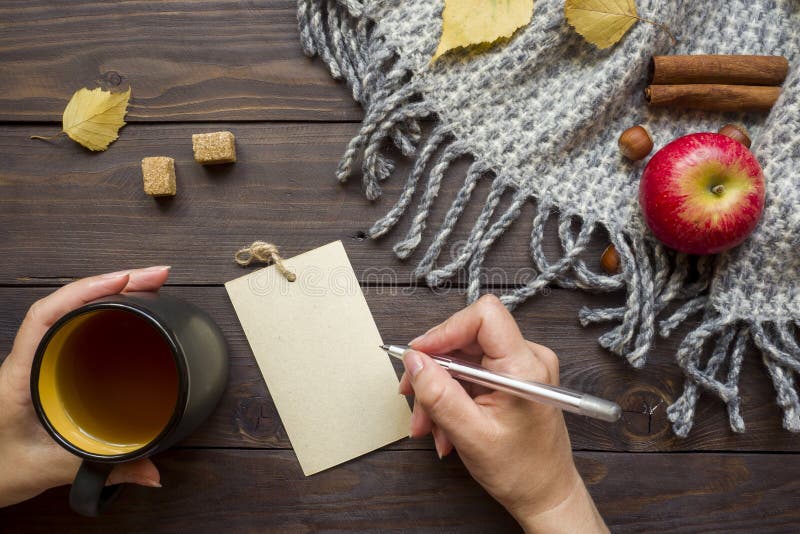 Concept of autumn cozy. Warm blanket with yellow leaves, Apple on dark wooden background. Concept of autumn cozy. Warm blanket with yellow leaves, Apple on dark stock photography Concept of autumn cozy. Warm blanket with yellow leaves, Apple on dark wooden background. Concept of autumn cozy. Warm blanket with yellow leaves, Apple on dark stock photography