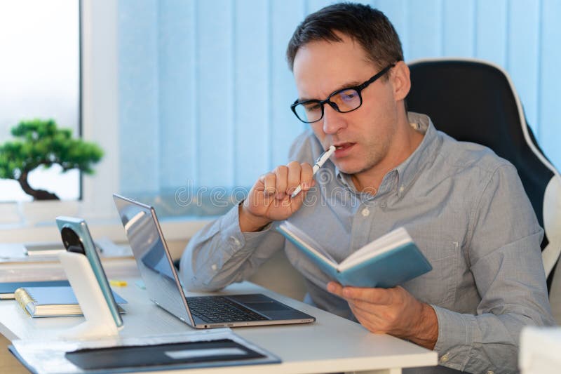 The concept of business planning is conceived. Businessman taking notes on notebook at office stock photo