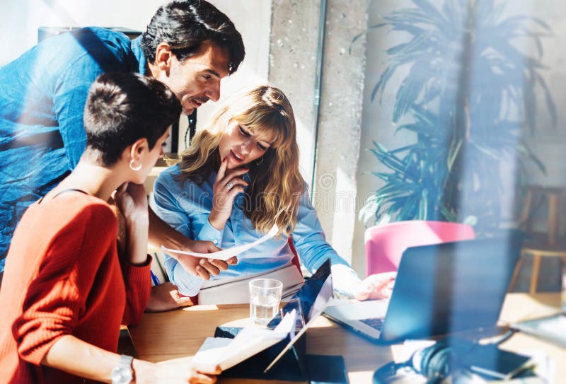 Concept of business team at working process.Young professionals work with new market project. Project managers meeting royalty free stock photo Concept of business team at working process.Young professionals work with new market project. Project managers meeting royalty free stock photo