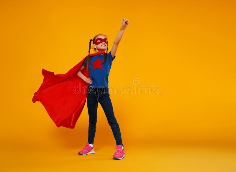 Concept of child superhero costume on yellow background stock image Concept of child superhero costume on yellow background stock image