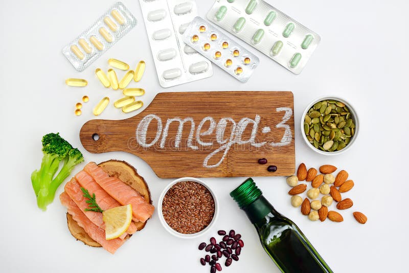 The concept of choosing between proper nutrition and medication. Layout of products with omega-3 and capsules with omega stock photo