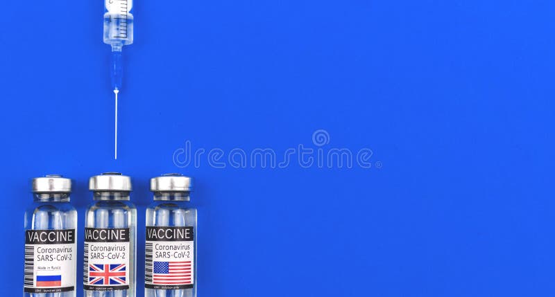 Concept of choosing vaccine for vaccination against COVID-19 in the world, vaccine vials with USA, UK and Russia flags