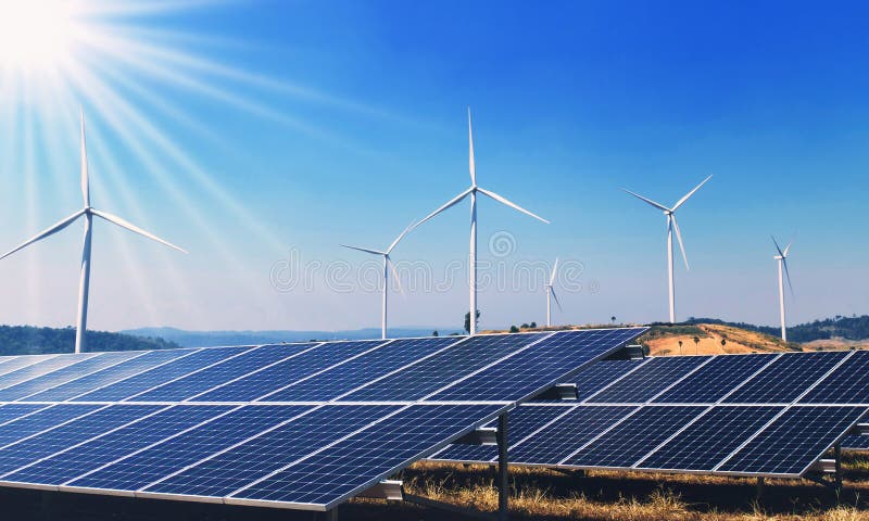 concept clean energy power in nature. solar panels and wind turbine stock photo