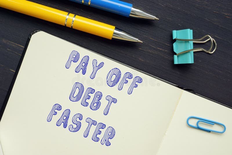 Business concept meaning PAY OFF DEBT FASTER with phrase on the piece of paper. Business concept meaning PAY OFF DEBT FASTER with phrase on the piece of paper.