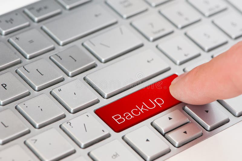 Concept of data protection: a finger press red backup button on laptop keyboard stock images