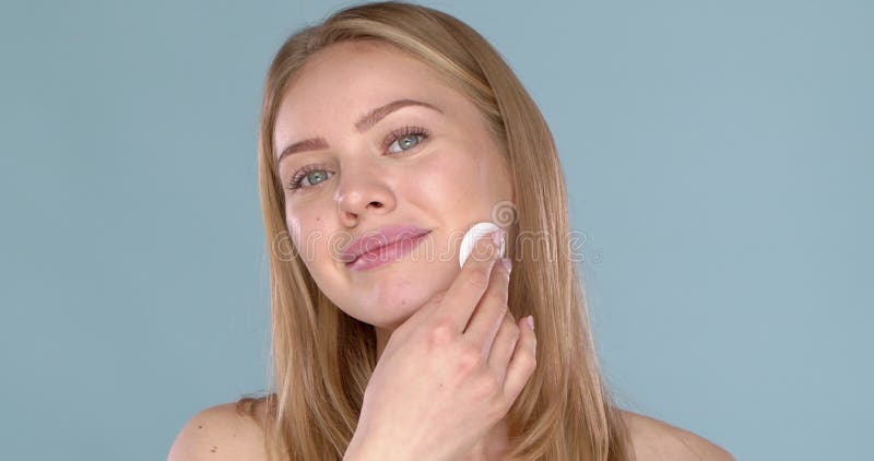 Concept de soins de la peau. Femme supprimant le maquillage du visage avec le gros plan sur le visage de protection de tampon de c