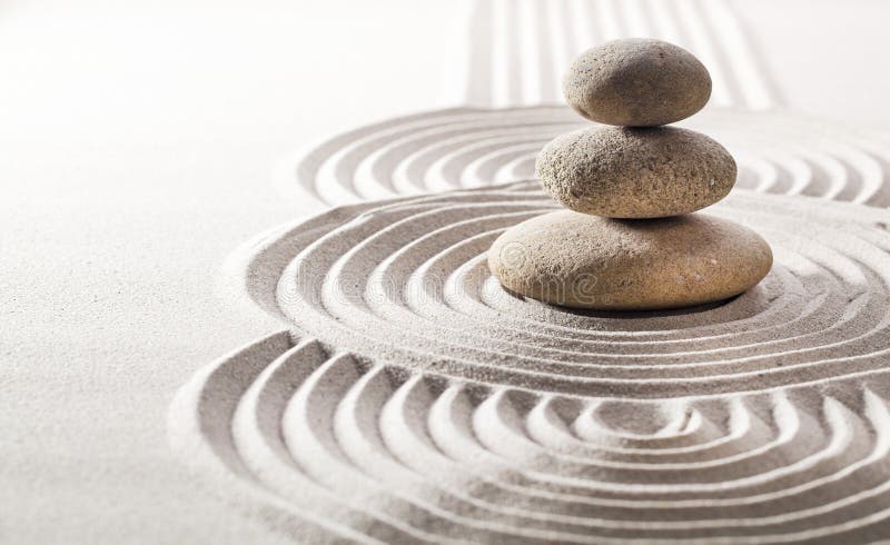 Succession of smooth circles in sand and balancing stones. Succession of smooth circles in sand and balancing stones