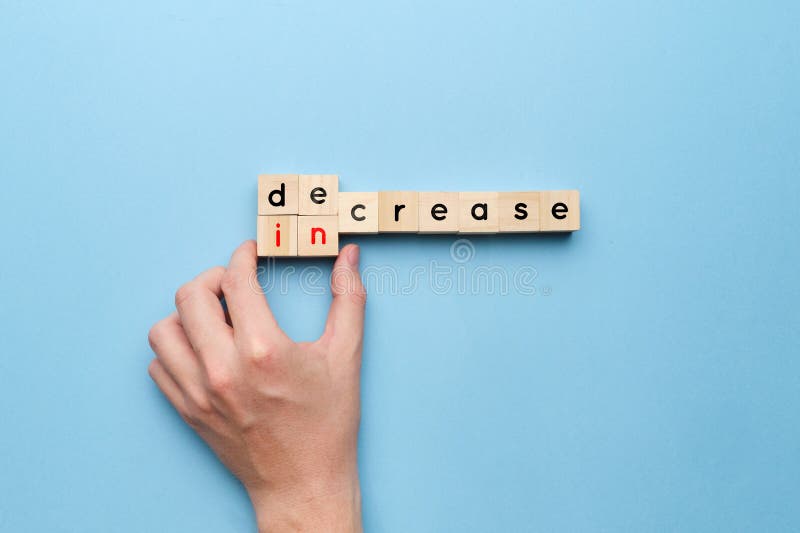 Concept of decrease and increase on wooden cubes. Decrease image stock images, royalty-free photos and pictures