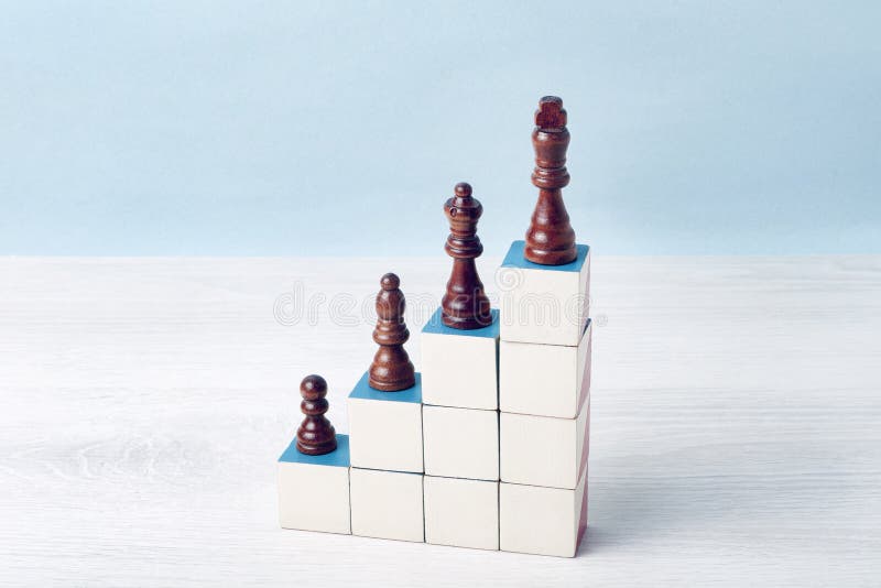 There are chess pieces on the stairs made of cubes. The pawn is on the first step, and the king is on the top step