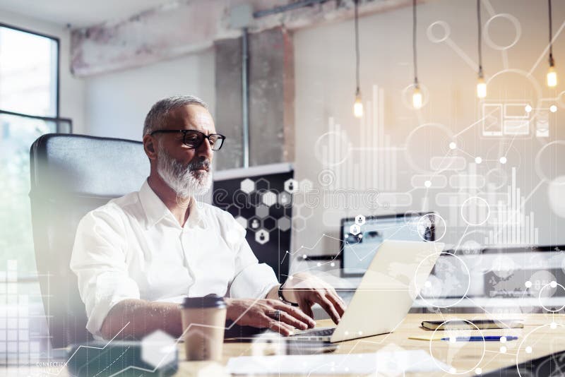 Concept of digital screen,virtual icon,diagram, graph and interfaces.Middle age financial analyst wearing a classic glasses and working at the wood table with exchange markets.Horizontal