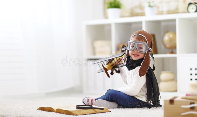 Concept of dreams and travels. pilot aviator child with a toy a royalty free stock photo Concept of dreams and travels. pilot aviator child with a toy a royalty free stock photo