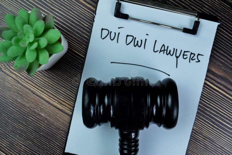 Concept of Dui Dwi Lawyers write on paperwork with gavel isolated on Wooden Table