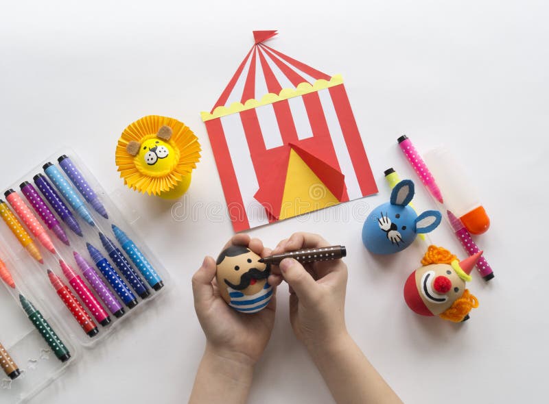 The concept of Easter with cute and cheerful handmade eggs, a rabbit, a clown, a strongman and a lion.