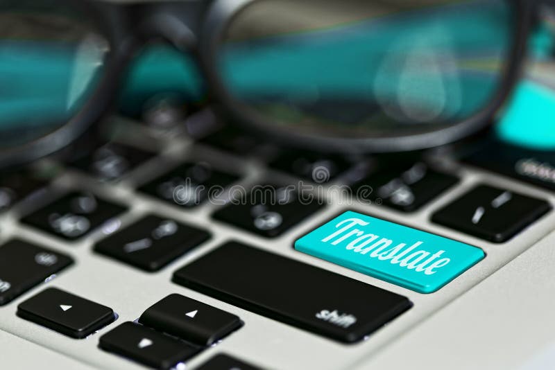 Online translator idea - macro close-up capture of laptop keyboard with translate key on it and eyeglasses. Blue color accent. Selective focus. Online translator idea - macro close-up capture of laptop keyboard with translate key on it and eyeglasses. Blue color accent. Selective focus.