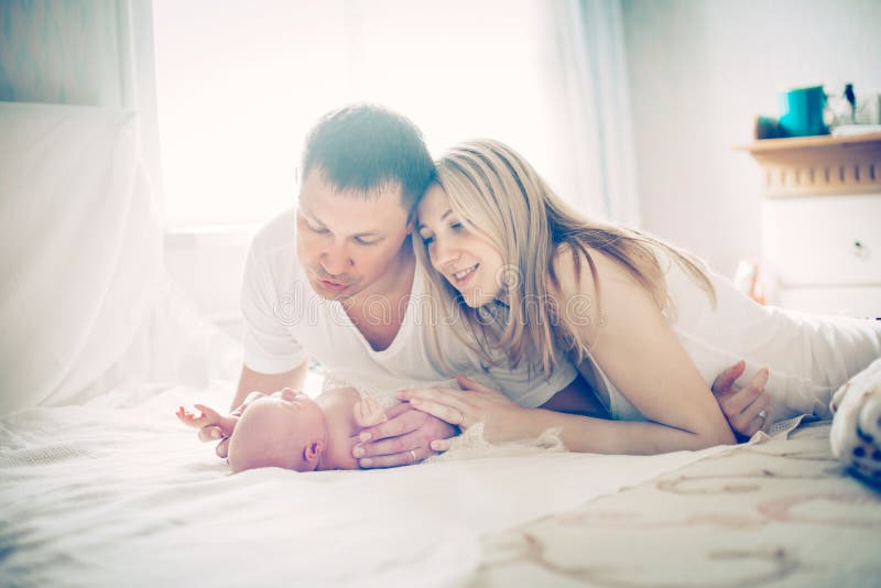 Concept of family happiness - happy parents and the newborn baby