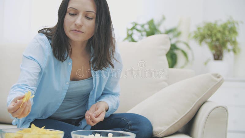 Slowmo Close Up Of Adorable Woman Who Is Chewing Pop Corn While Watching TV With Surprise