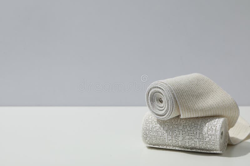 Concept of first aid, different bandage on white table royalty free stock photos