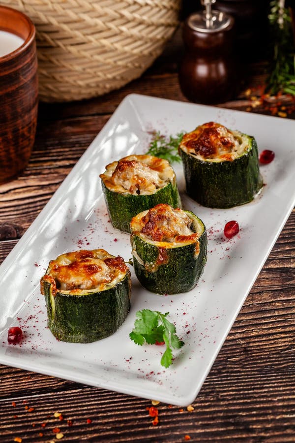 Concept of Georgian cuisine. Stuffed zucchini with minced lamb meat, Suluguni cheese. Serving dishes in a restaurant