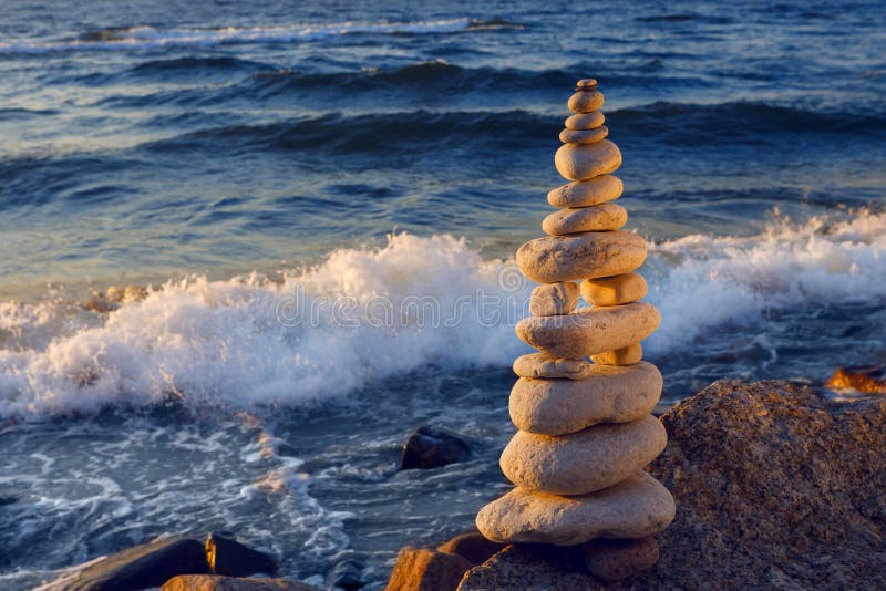 Concept of harmony and balance. Rock Zen at sunset. Balance and poise stones against the sea.
