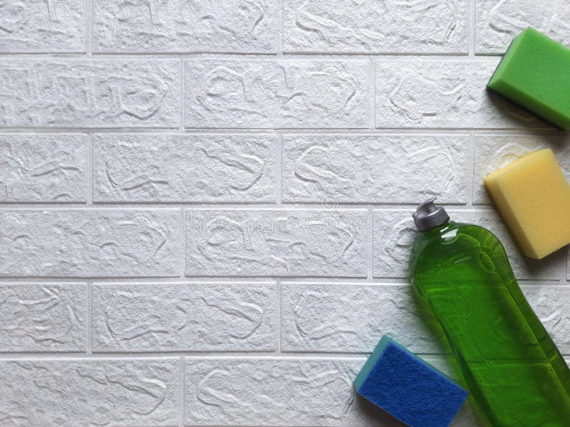 On White Brick Wall with Space for Text Lie Multi Colored Kitchen