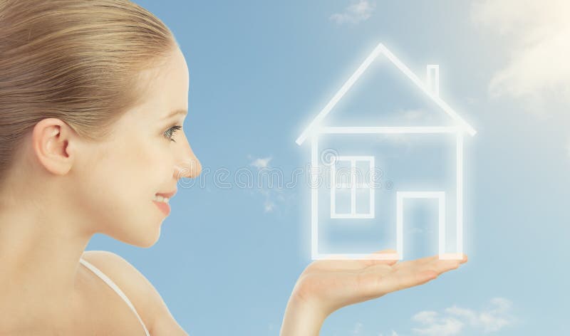 Concept housing. woman holding a house