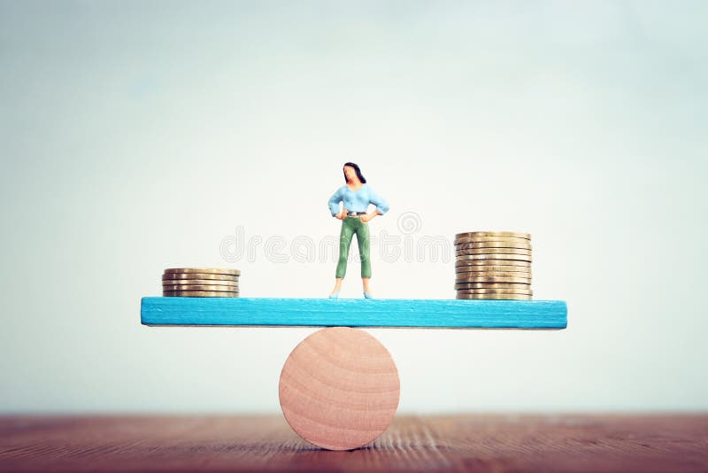 Concept image of woman balancing stack of coins on seesaw royalty free stock photography