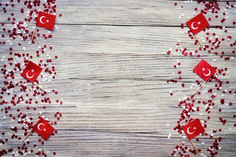 concept-independence day of Turkey, national paper flags of the state of Turkey with white red confetti on a white brushed wooden