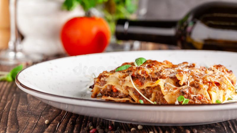 The concept of Italian cuisine. Lasagna with minced meat, bechamel sauce and parmesan cheese. Close up. Serving dishes