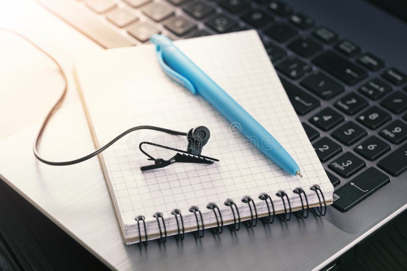 Concept for online conference, stream, webinar. Wired Microphone, notepad and laptop are prepared for video communication over the Internet, top view