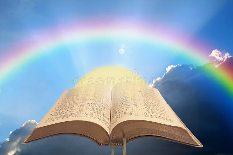 Concept photo of divine spiritual light showing open holy bible with sun rising and rainbow arc against a stormy sky ideal for own text. Concept photo of divine spiritual light showing open holy bible with sun rising and rainbow arc against a stormy sky ideal for own text.