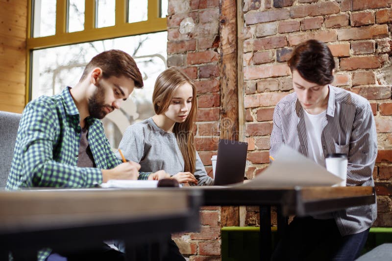 Concept of presentation new business project. Group of young coworkers discussing ideas with each other in modern office. stock photos Concept of presentation new business project. Group of young coworkers discussing ideas with each other in modern office. stock photos