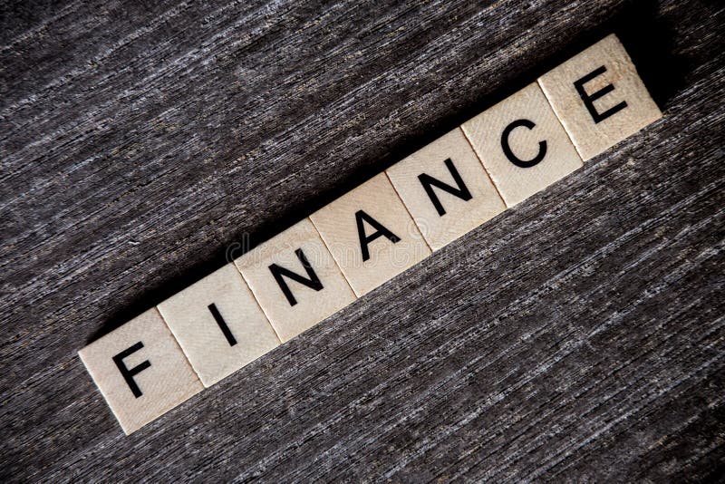 Concept presented by crossword with words finance with wooden cu stock photography Concept presented by crossword with words finance with wooden cu stock photography