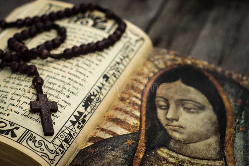 A Religious concept of a rosary and a bible on wood background. A Religious concept of a rosary and a bible on wood background